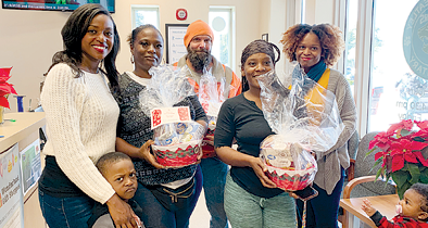 Ashlen Bond-Lilly distributes 100 holiday food baskets to Phillis Wheatley Elementary School