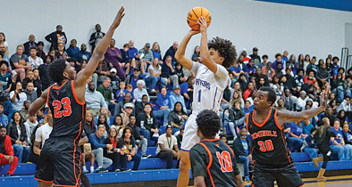 Apopka boys basketball's Rafael Betancourt takes a jump shot against Sanford defenders.
