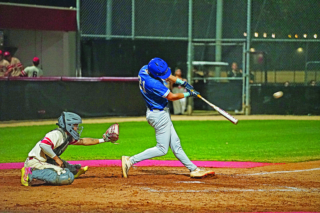 A batter makes great contact on a ball as it explodes off the bat