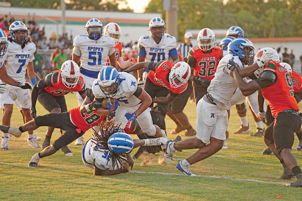Apopka's Elijah Frazier barrels through a wall of Jones defenders on his way into the end zone on Friday, May 23.