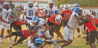 Apopka's Elijah Frazier barrels through a wall of Jones defenders on his way into the end zone on Friday, May 23.