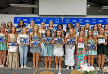 The Apopka JV and varsity softball teams stand together with their plaques after the banquet on Tuesday, May 27.