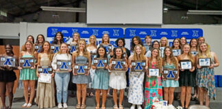 The Apopka JV and varsity softball teams stand together with their plaques after the banquet on Tuesday, May 27.