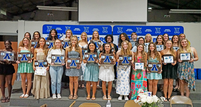 The Apopka JV and varsity softball teams stand together with their plaques after the banquet on Tuesday, May 27.