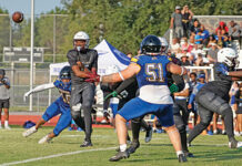 Wekiva’s quarterback gets a pass off just in time as a Lyman defensive end wraps around his leg after breaking into the pocket. 