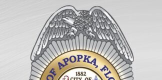 A logo of the Apopka Police Department resembling a bad, with gray and gold colors, and city of Apopka seal in the center.
