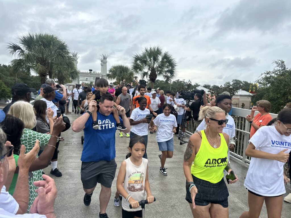 A group of people in workout clothes jog outdoors in a race.