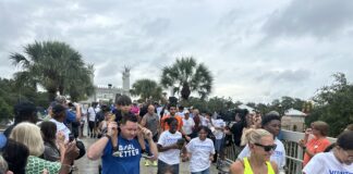 A group of people in workout clothes jog outdoors in a race.