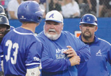 During a game, former head coach of the Apopka baseball team, Bobby Brewer talks with a batter about what to look for at the plate