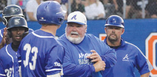 During a game, former head coach of the Apopka baseball team, Bobby Brewer talks with a batter about what to look for at the plate