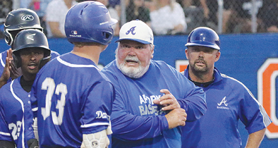 During a game, former head coach of the Apopka baseball team, Bobby Brewer talks with a batter about what to look for at the plate