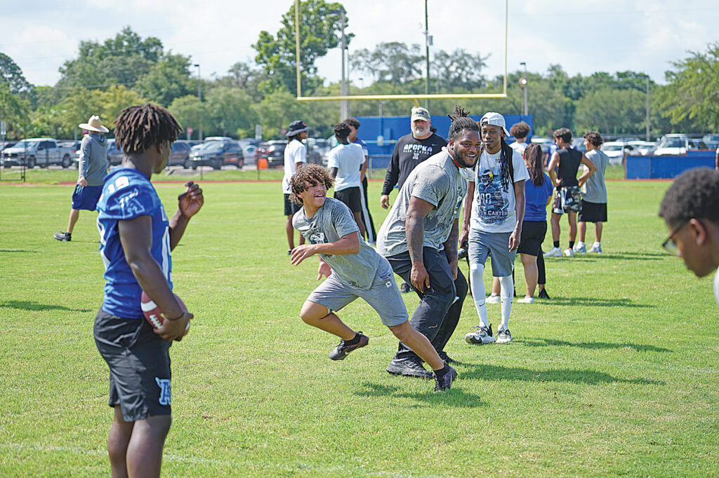 Jalen Carter works with receivers at his camp on making separation at the line last year.
