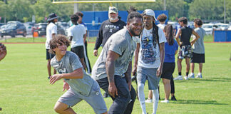 Jalen Carter works with receivers at his camp on making separation at the line last year.