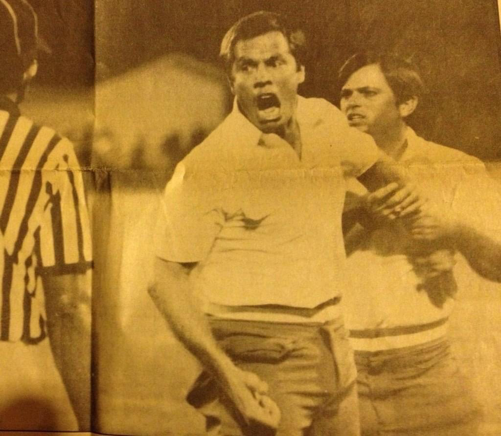 Hall of Fame former head coach of the Apopka Football team, Chip Gierke, speaks his mind to an official while being held back by Sonny Wise.