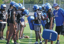 Apopka football's previous head coach, Jeff Rolson, talks with linebackers during a drill at spring practice.