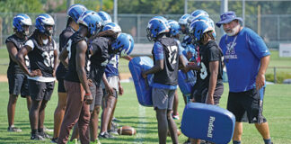 Apopka football's previous head coach, Jeff Rolson, talks with linebackers during a drill at spring practice.