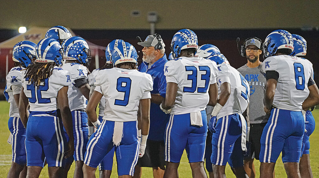 Apopka's former head coach, Jeff Rolson, speaks with his defense about adjustments during a timeout.
