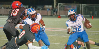 Tyson Davison uses his speed and agility to maneuver past multiple West Orange defenders.