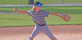 A member of Apopka Little League’s Majors All-Star team puts everything he has into a throw to first base.