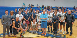 The Apopka Fire and Police Departments stand together after the third Dreams of Joy charity basketball game on Friday, May 30. Apopka's Fire Department took home the win 84-43.