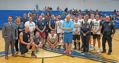 The Apopka Fire and Police Departments stand together after the third Dreams of Joy charity basketball game on Friday, May 30. Apopka's Fire Department took home the win 84-43.