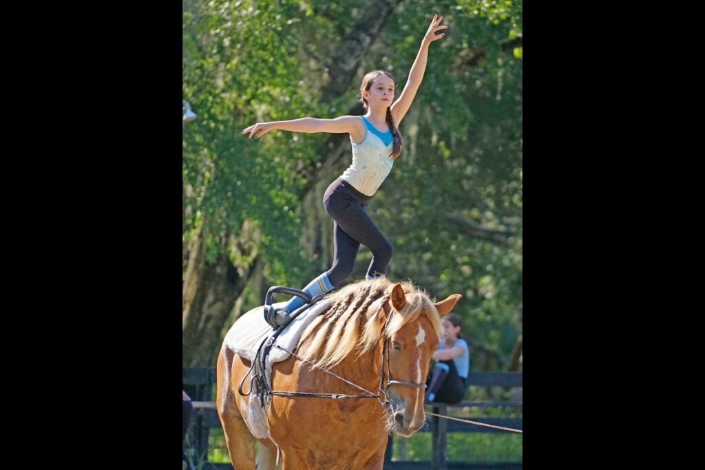 Laura Heath stands atop Westley as she practices a routine.