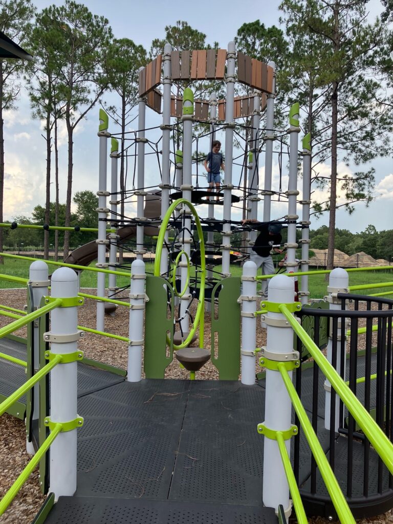Kids climb onto apparatus at all-inclusive playground.