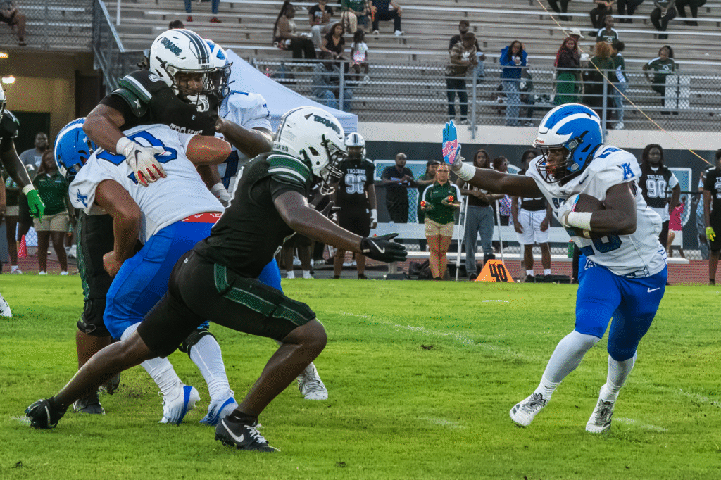 Senior Brian Jean lays out a stiff arm.