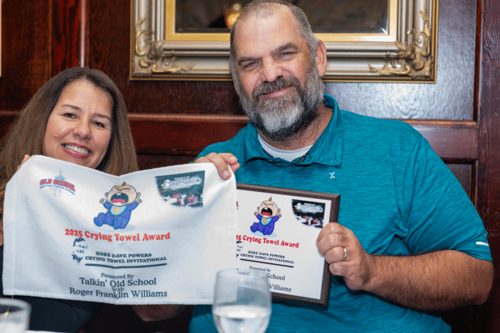 Giovanna and Andy Johnson hold the Crying Towel with the Crying Towel award.