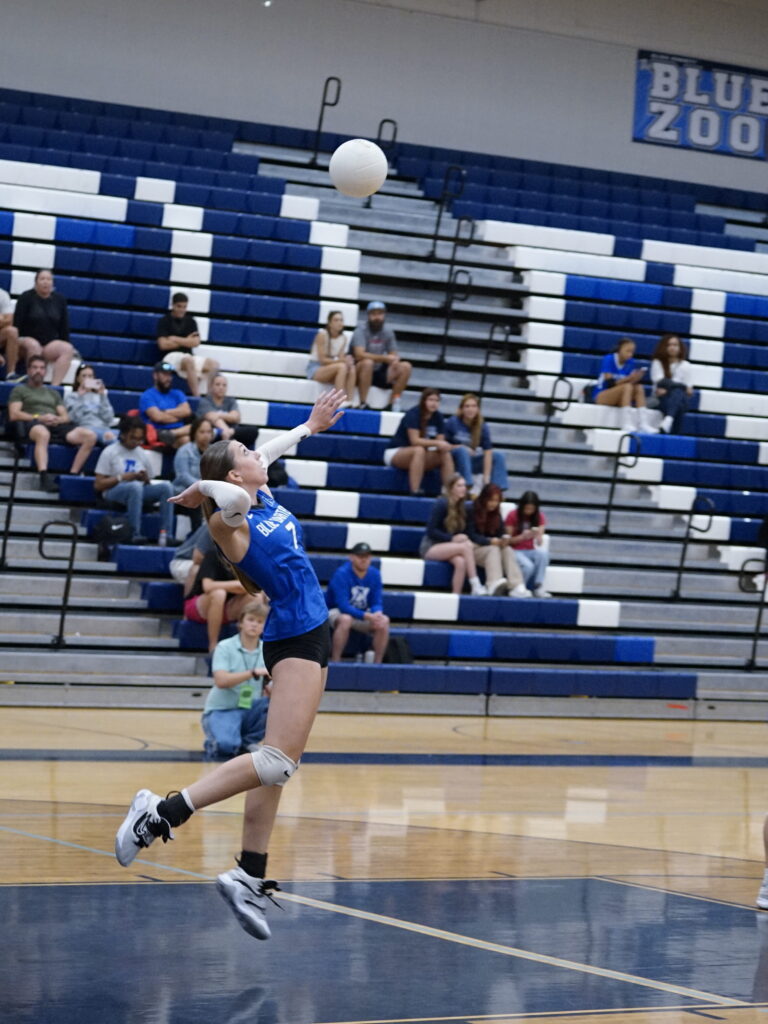 Senior Madeline Sherrer on serve.
