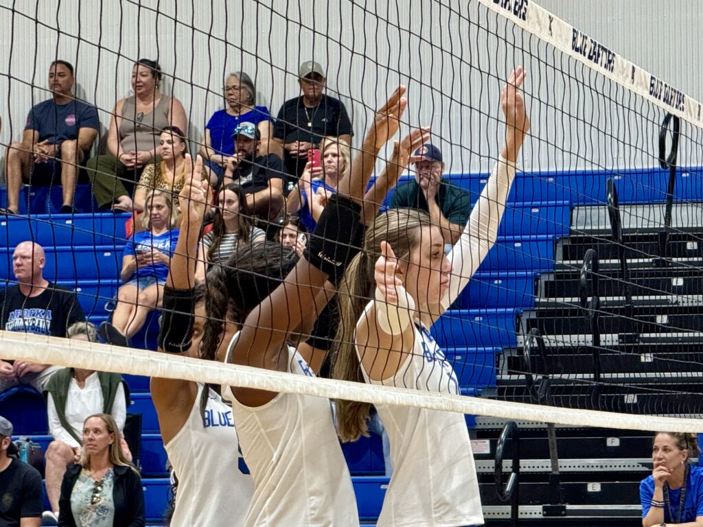 Madison Sherrer, Brianna Young, and Kiana Napier guarding the net.