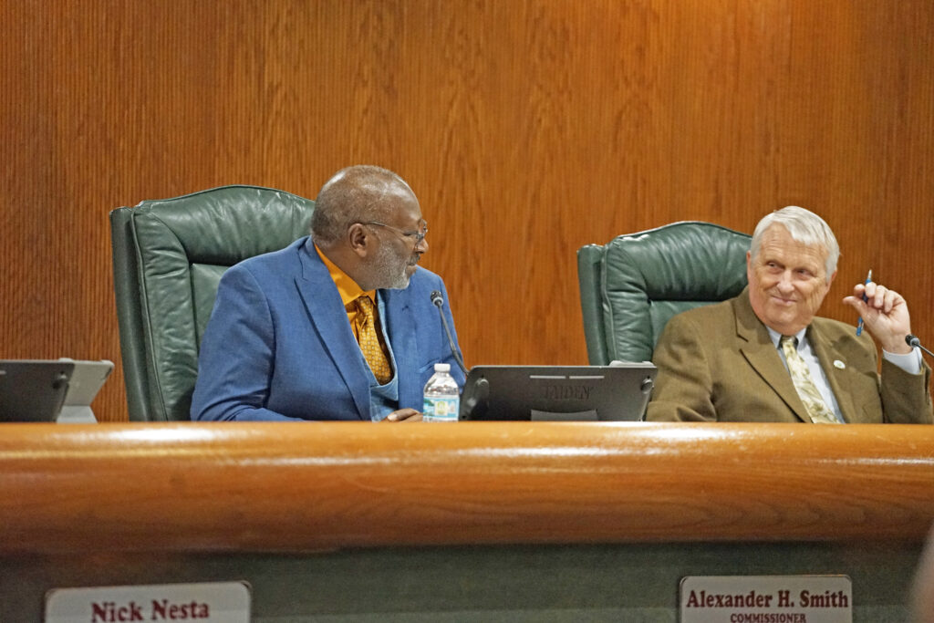 Apopka City Commissioner Alexander H. Smith (L) and Mayor Bryan Nelson (R) speak at a recent meeting.