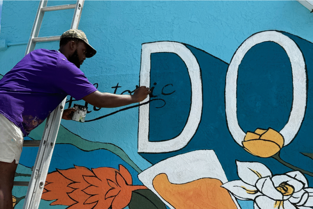 Ridge Bonnick adds final touches to the Downtown Mural.
