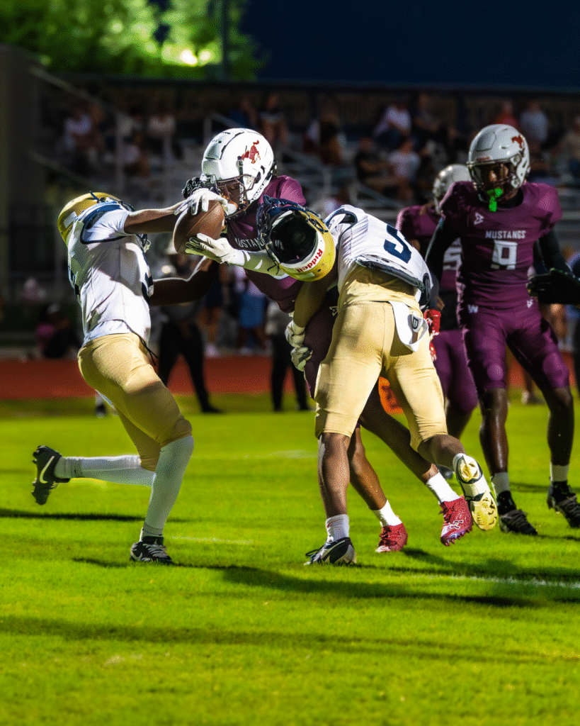 Jaden Saint George diving through defenders at the goal line.