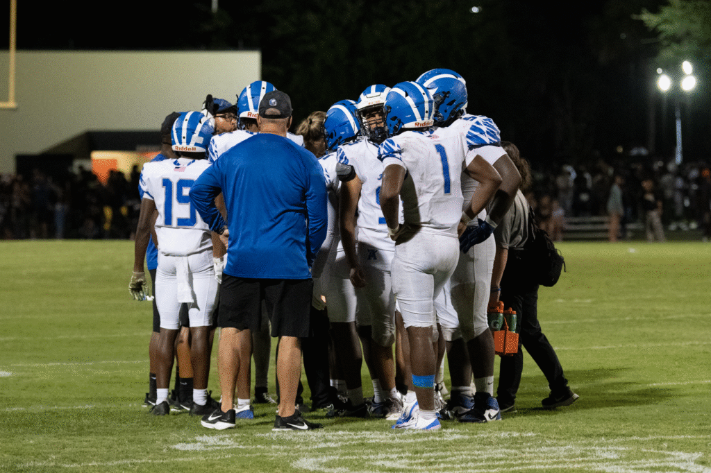 Blue Darters huddle during a timeout.
