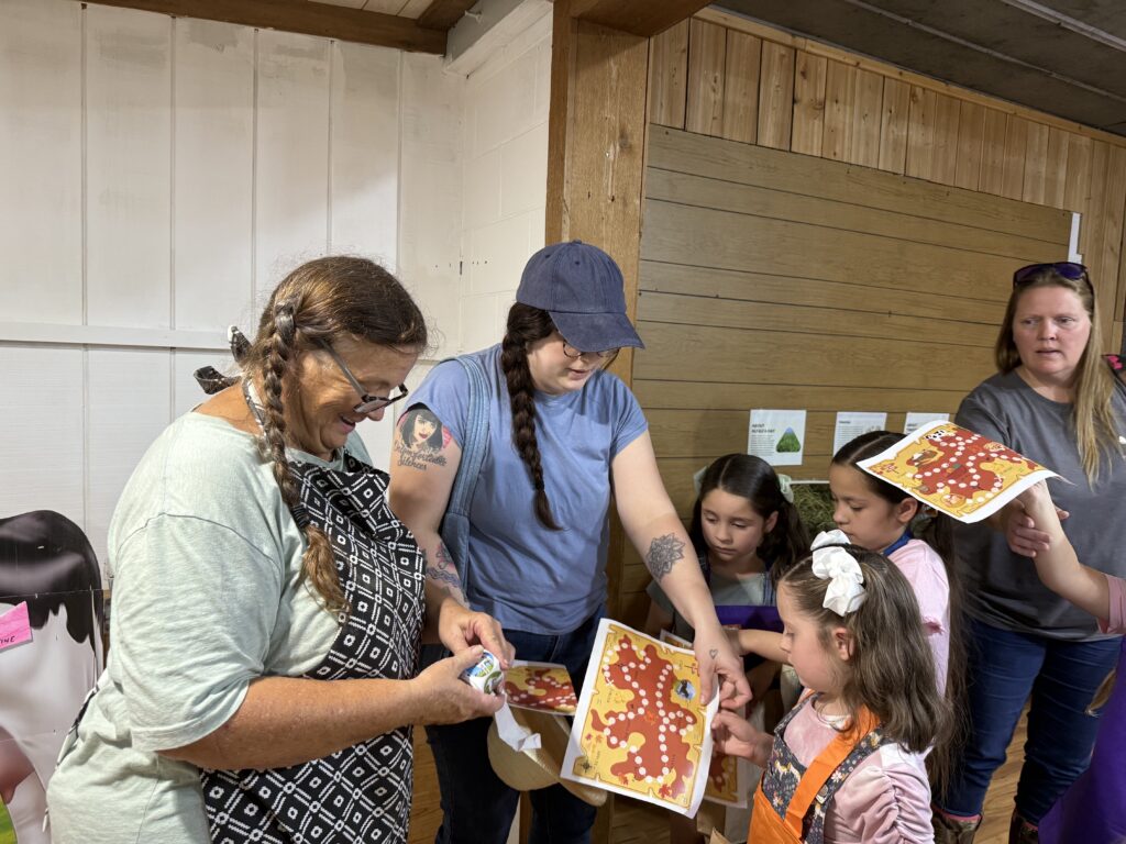 Dawn Pelletier gives kids stickers for their scavenger hunt sheet at the Sept. 20 fall masterclass.