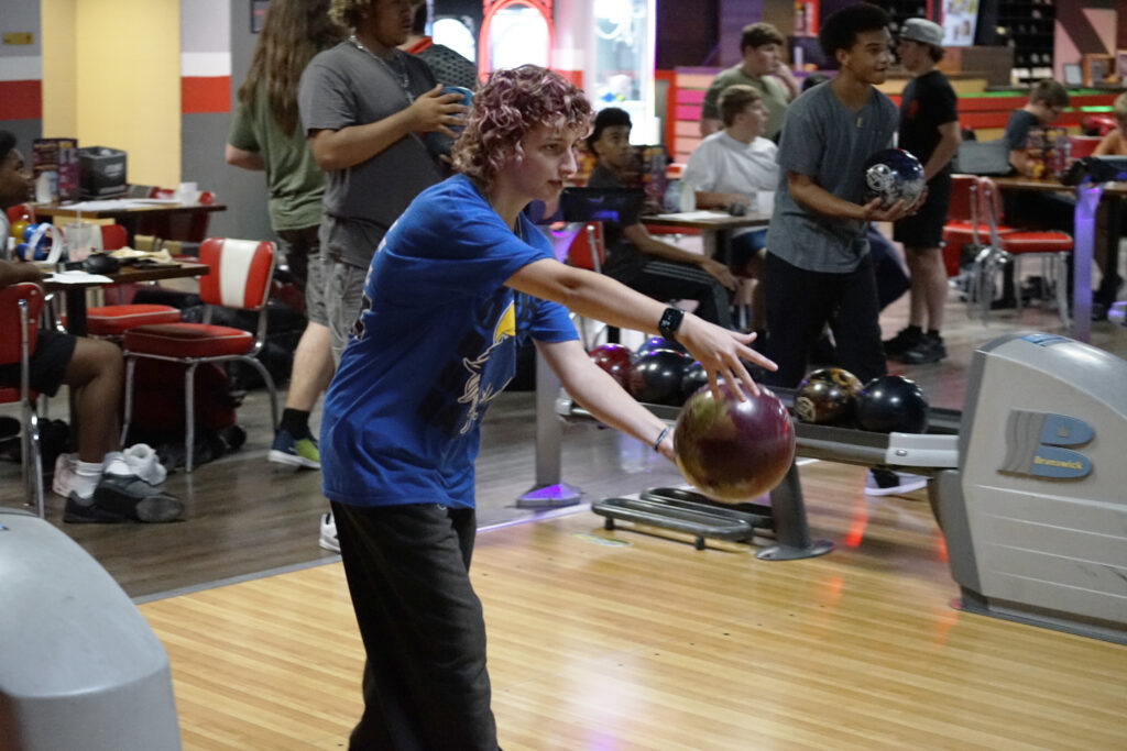 A member of the girls' bowling team prepares to send a ball down the lane during practice.