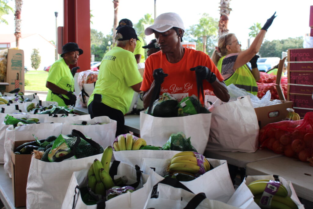 Volunteers handle food for distribution to 500 families on Sept. 11 at the Patmos Chapel Community Service Center in Apopka. Courtesy of Second Harvest Food Bank of Central Florida.
