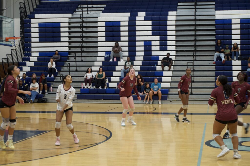 Mustangs receiving serve and getting in position.