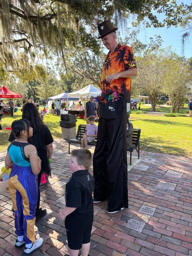 Entertainers toured the park much to the astonishment of many little ones—stilt walkers, inflatable dinosaurs, ghouls and goblins popped up between the booths.