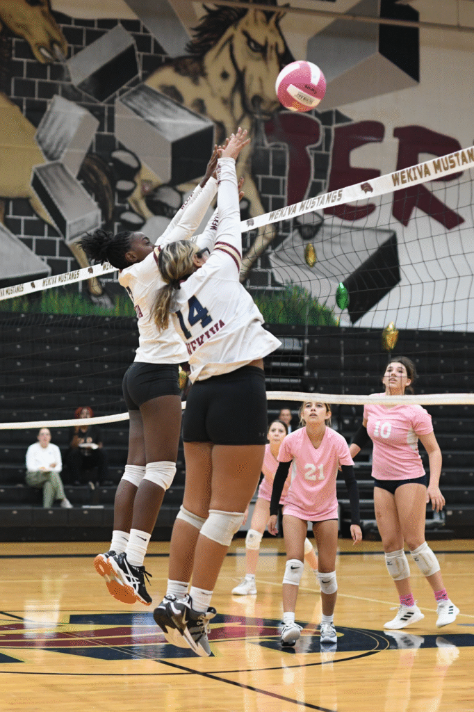 Asheley Touze and Misha Mancilla rise up for a block