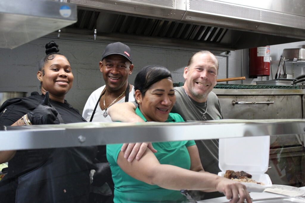 Chef Philly, Uncle Champie, Laurie Williamson and Chris Lang pose for the camera.