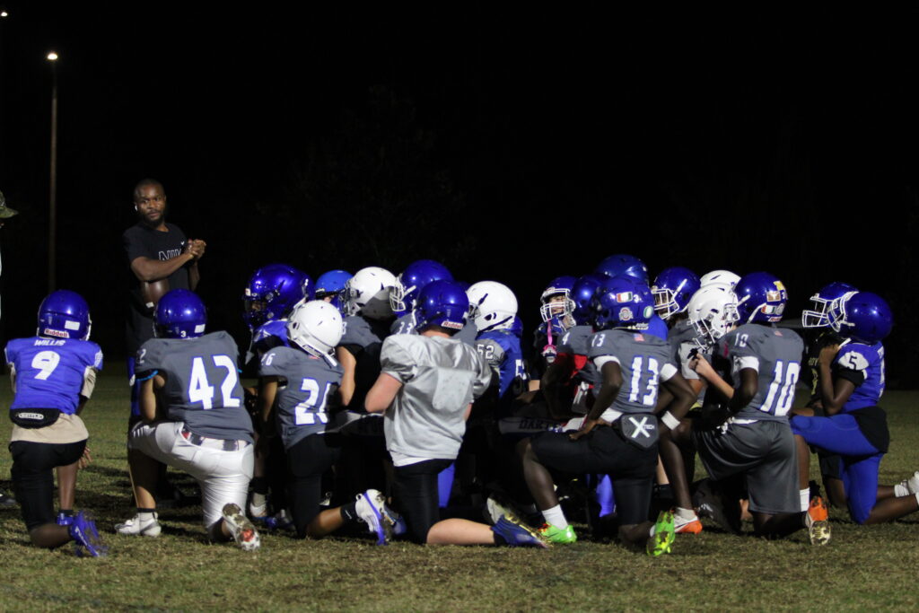 Coach Bryant motivates the players post practice