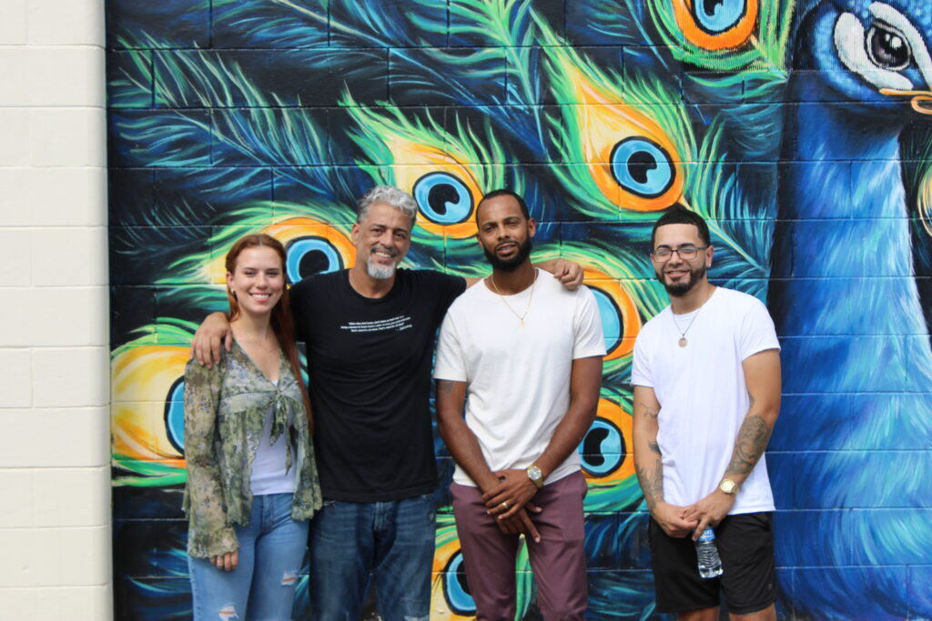 From left to right: Savannah Vargas, Luis Rivera, Jordan Jones and Michael Delgado huddle after signing the murals.