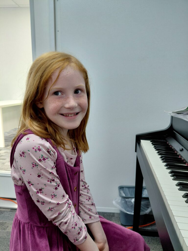 Grace Notes Apopka student Madeleine Wilson learns piano in one of the new classrooms.