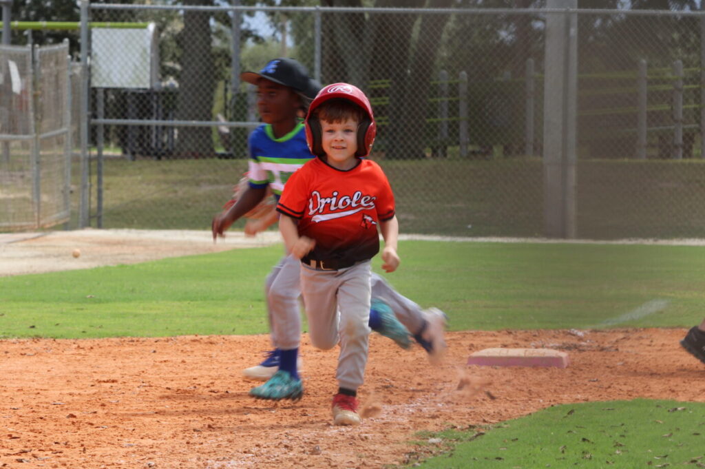 Little Leaguer happily on his way to the promise land, home base
