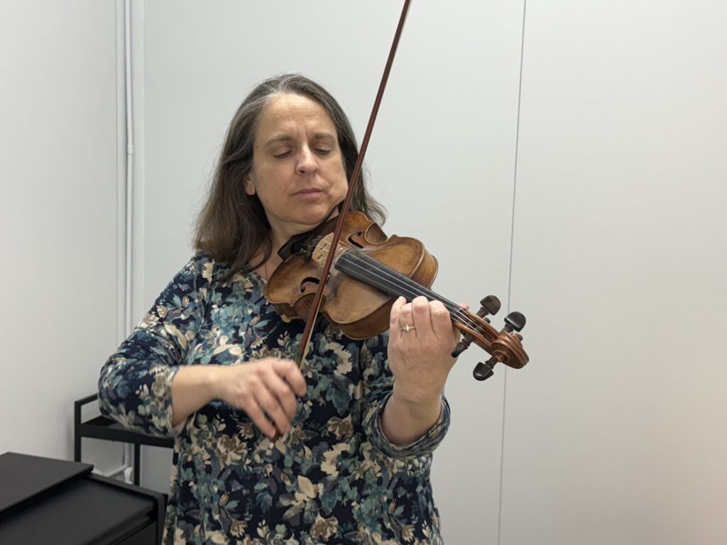 Michelle Martin plays a scale and arpeggio on her favorite instrument—the violin.