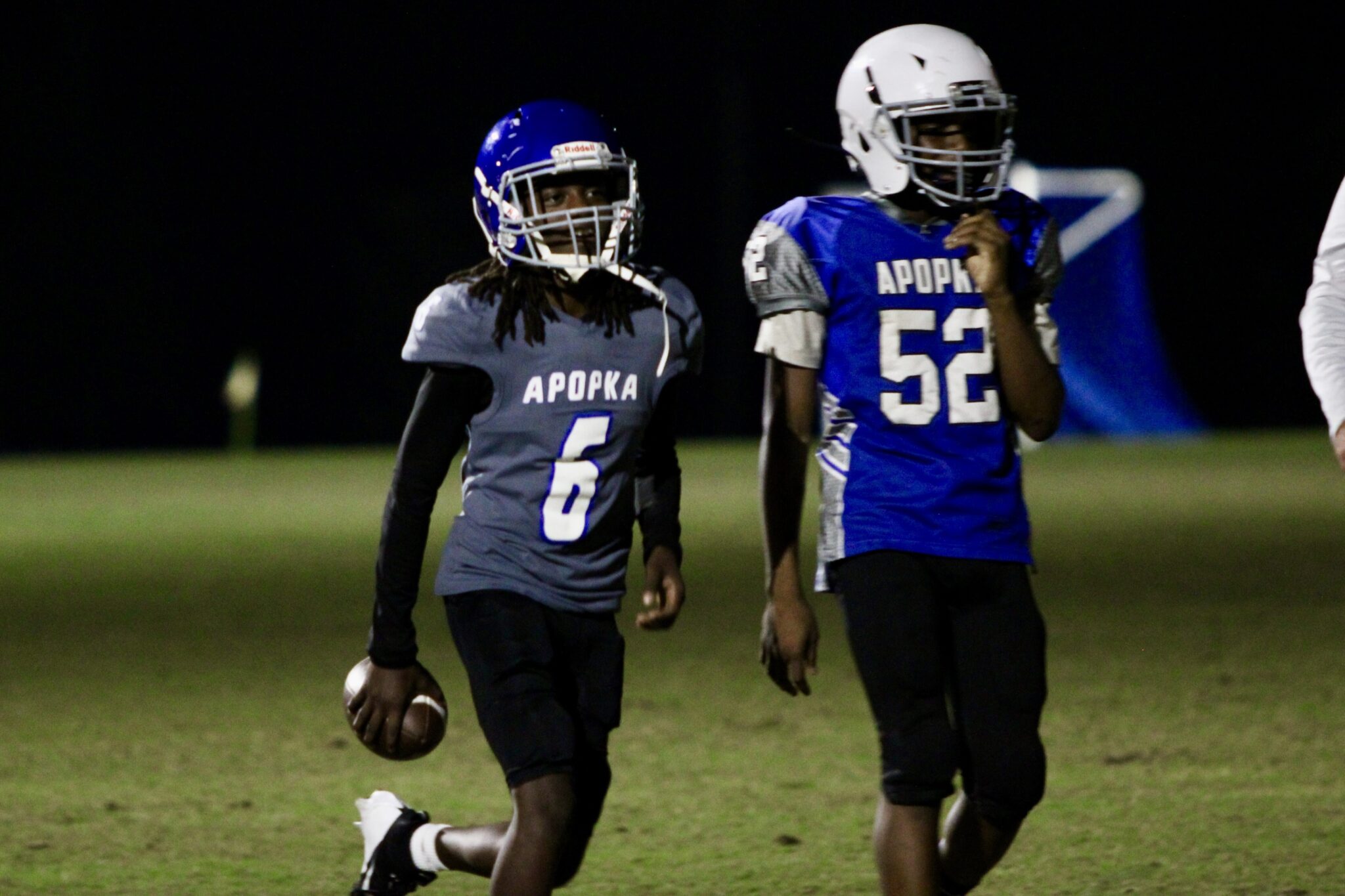 Blue Darter wide receiver jogging back to the huddle