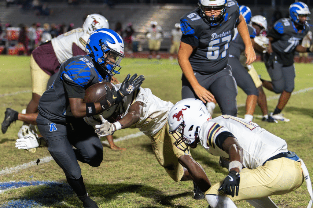 Jensen Simon wraps up Jakyvion Kemp on the sideline
