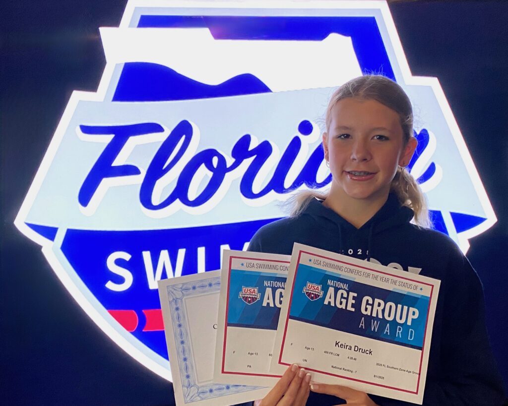 Keira Druck receives her 3 certificates at the 2025 Florida Swimming Awards Banquet
